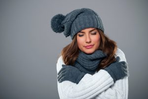 woman-in-hat-scarf-gloves-shivering