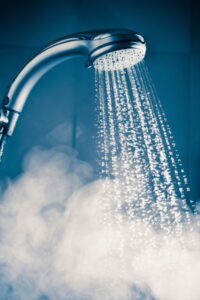 hot-water-flowing-from-showerhead-creating-steam